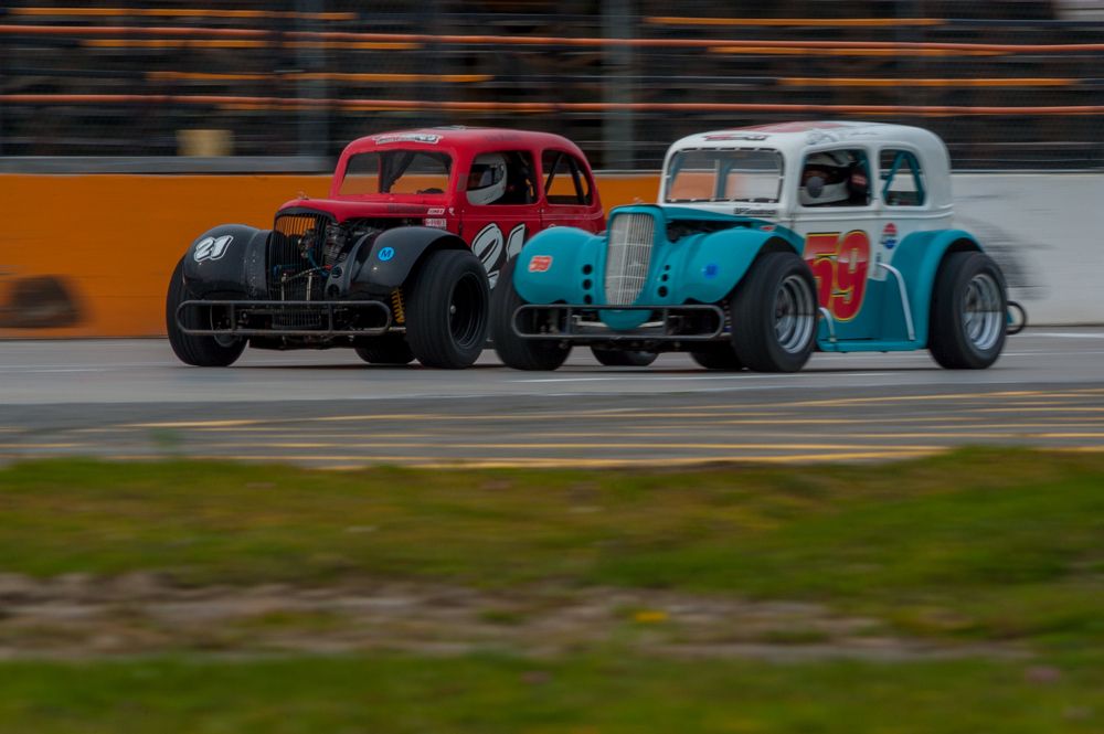 Side-by-side Legends racing car on the final lap.