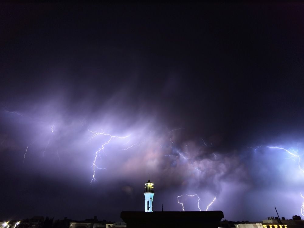 Lightning with the minaret of the mosque