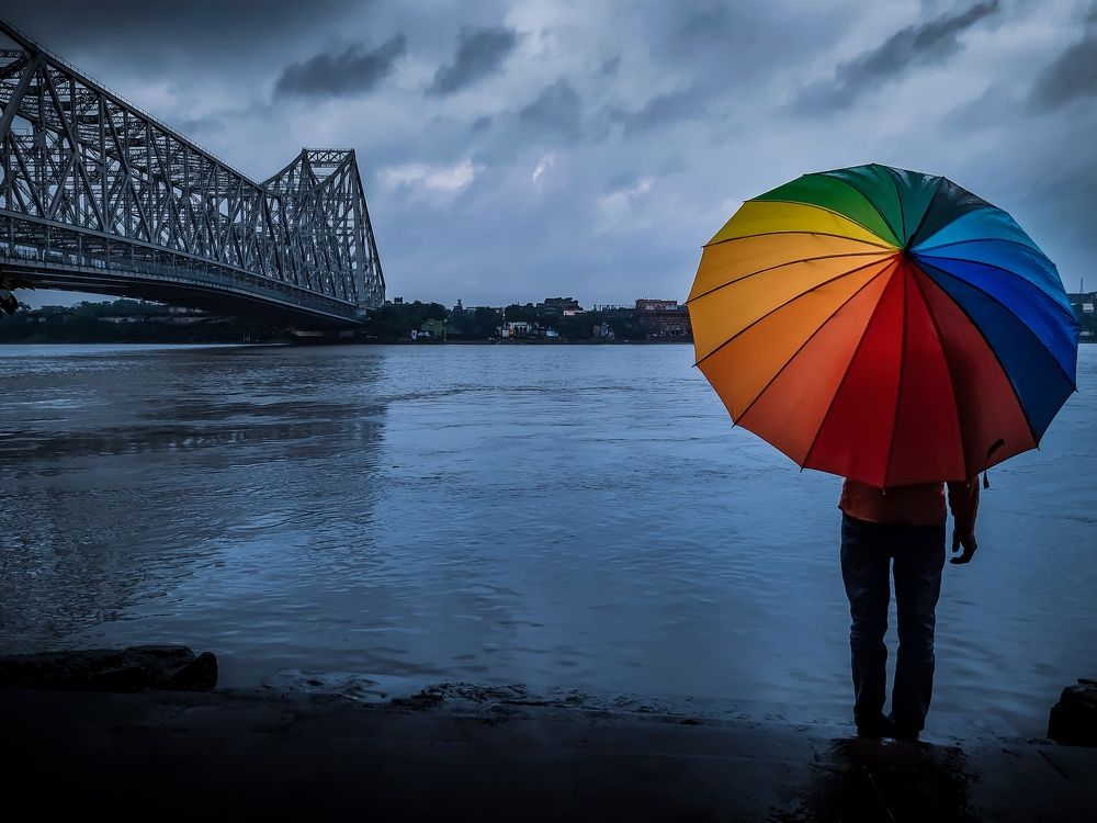 The Man With Colourful Umbrella & The Howrah Bridge