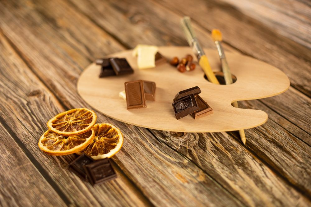 Assorted chocolates are set on an art palette