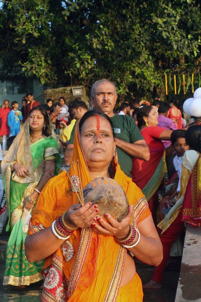 THE DEVOTEE PERFORMS CHHAT PUJA.