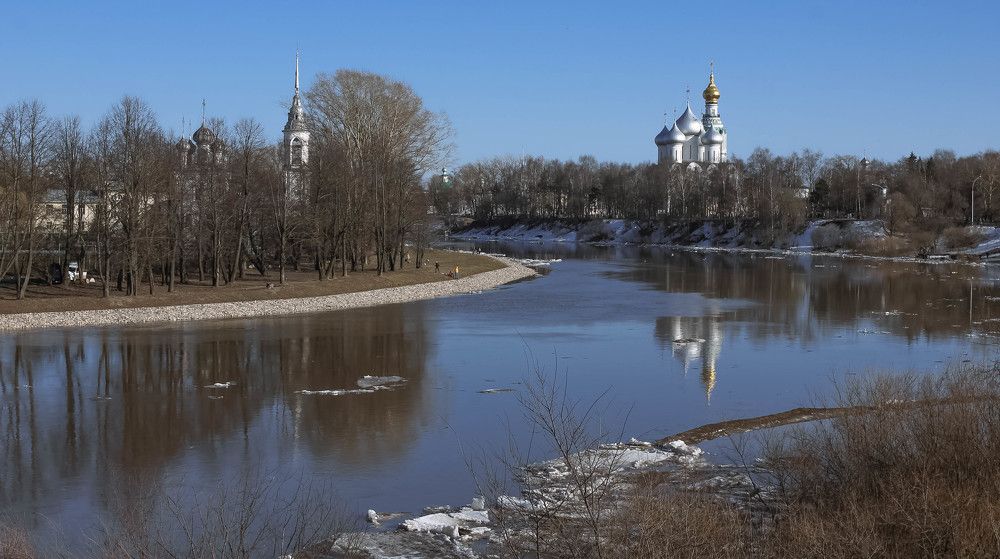 The Church of the Presentation of the Lord and St. Sophia Cathedral in the distance on the banks of the river on a clear April day