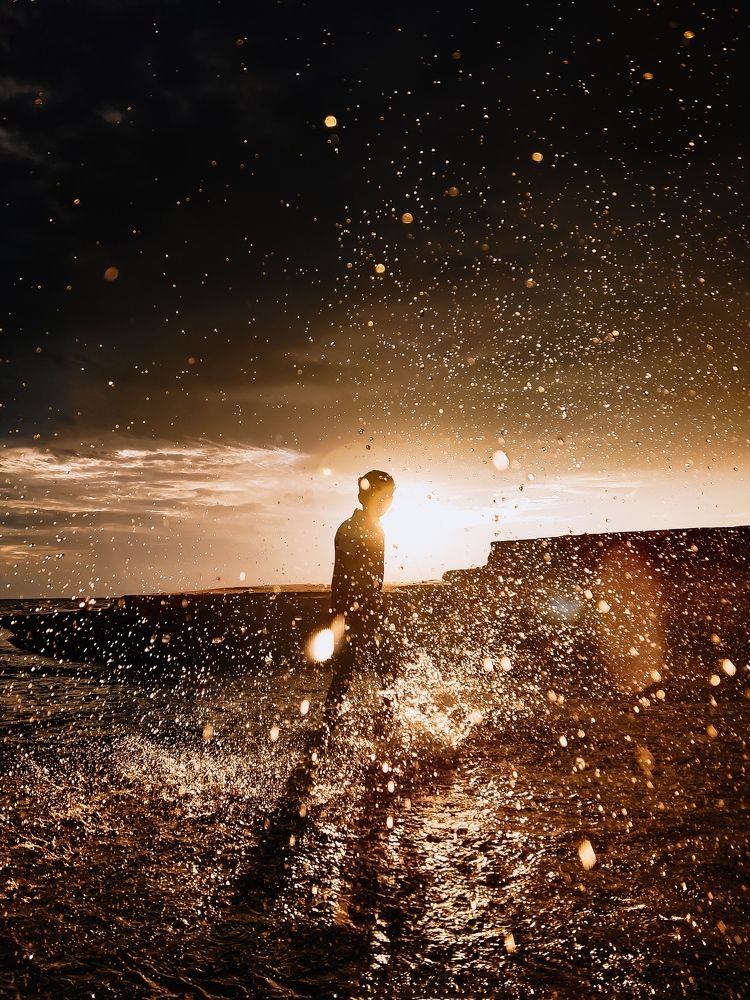 Embracing the joys of childhood: A care free spirit makes a splash in the water