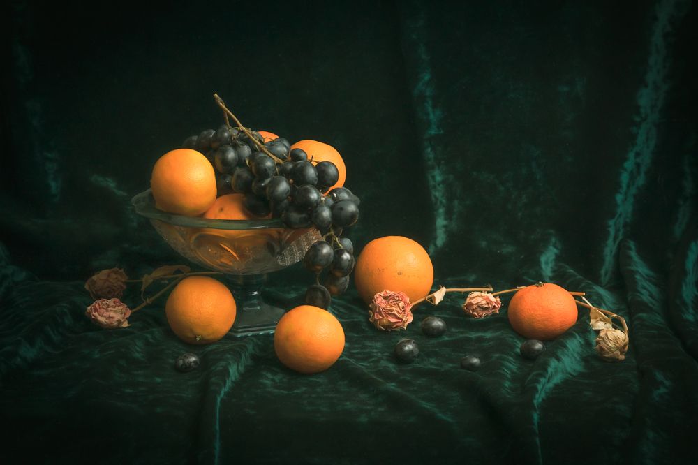 Still life with oranges and black grapes