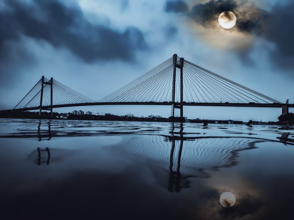 The Second Hooghly Bridge And It's Reflection On A Moonlit Night.