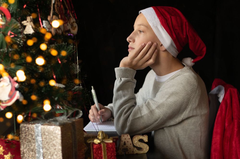 The boy sitting in Santa's hat