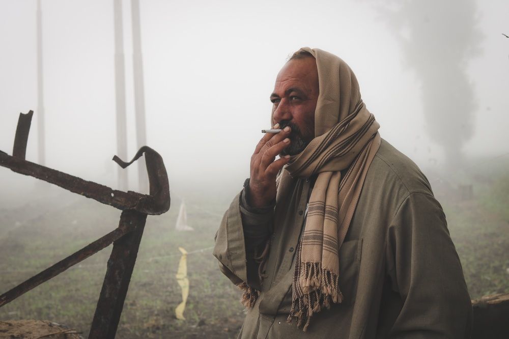 A farmer drinks a cigar