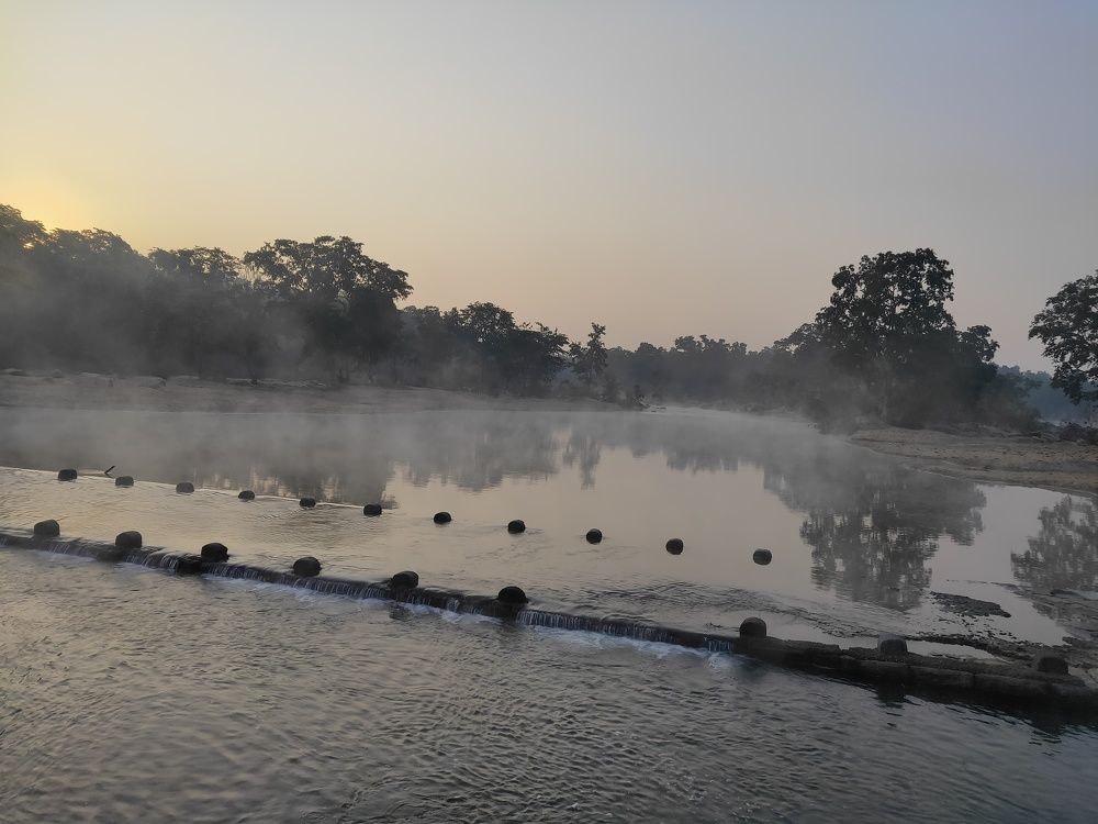 Fog shifting slowly across the stream