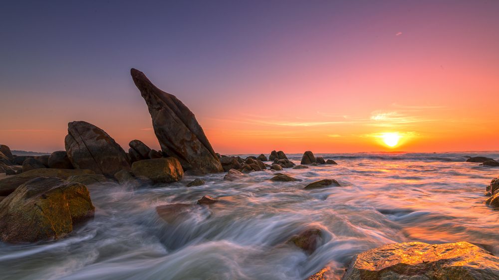 Rocks and waves in the sun rise