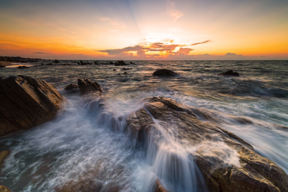 Rocks and waves in the sun rise
