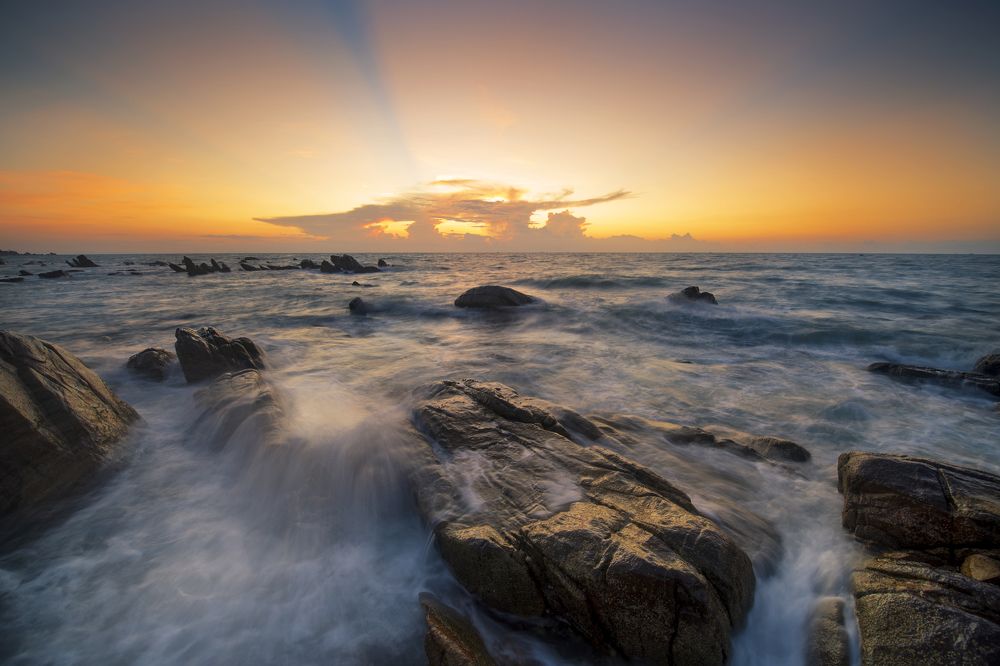 Rocks and waves in the sun rise