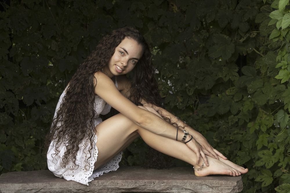 Virginie sitting on the stone bench