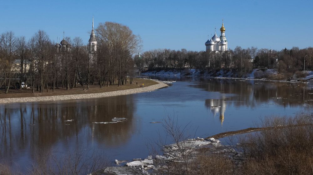 The Church of the Presentation of the Lord and St. Sophia Cathedral in the distance on the banks of the river on a clear April day