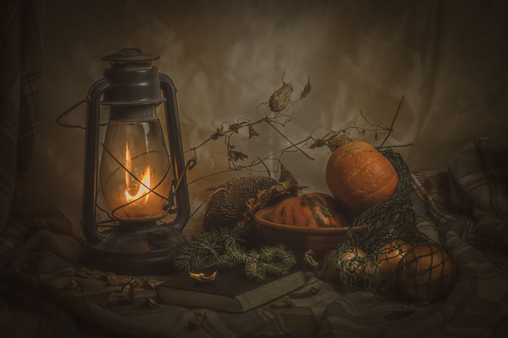 Still life with a kerosene lamp and pumpkins