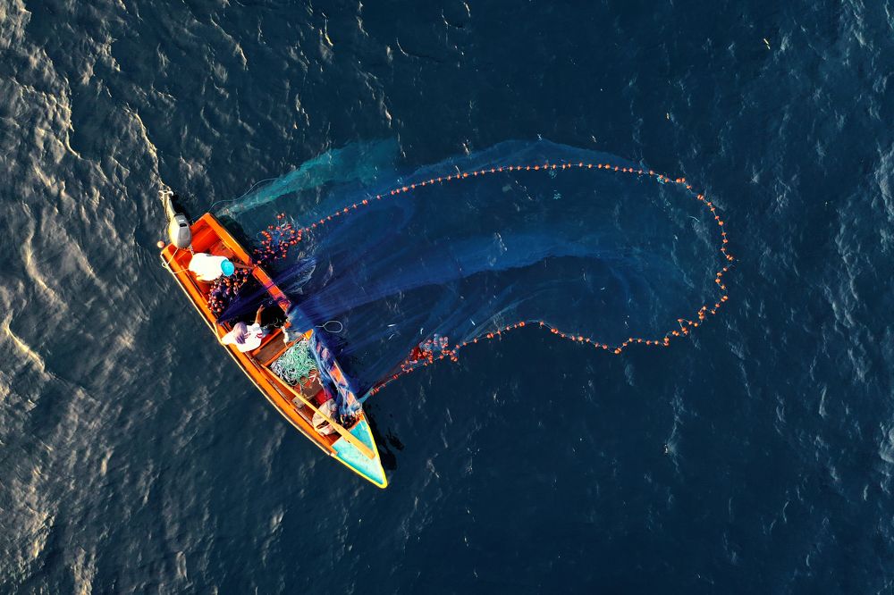 Fishermen casting their net