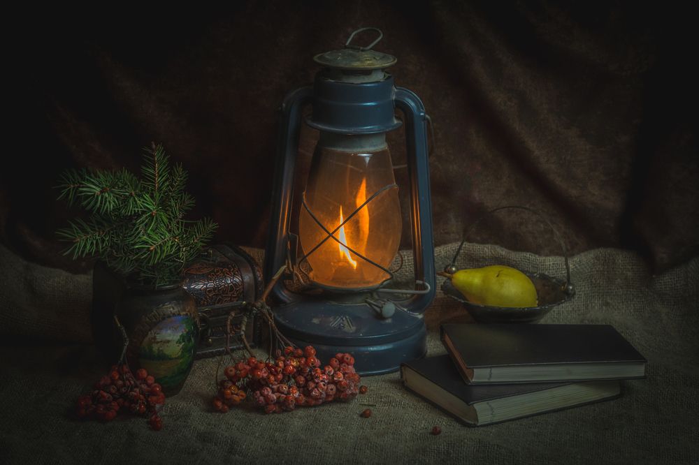 Still life with a kerosene lamp and a pear