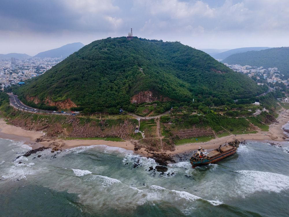 Drifted Cargo ship with tortoise shaped hill in background
