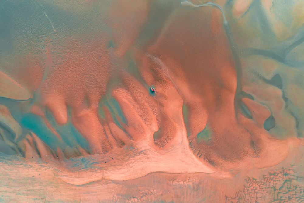 The abandoned boat in the middle of the river.