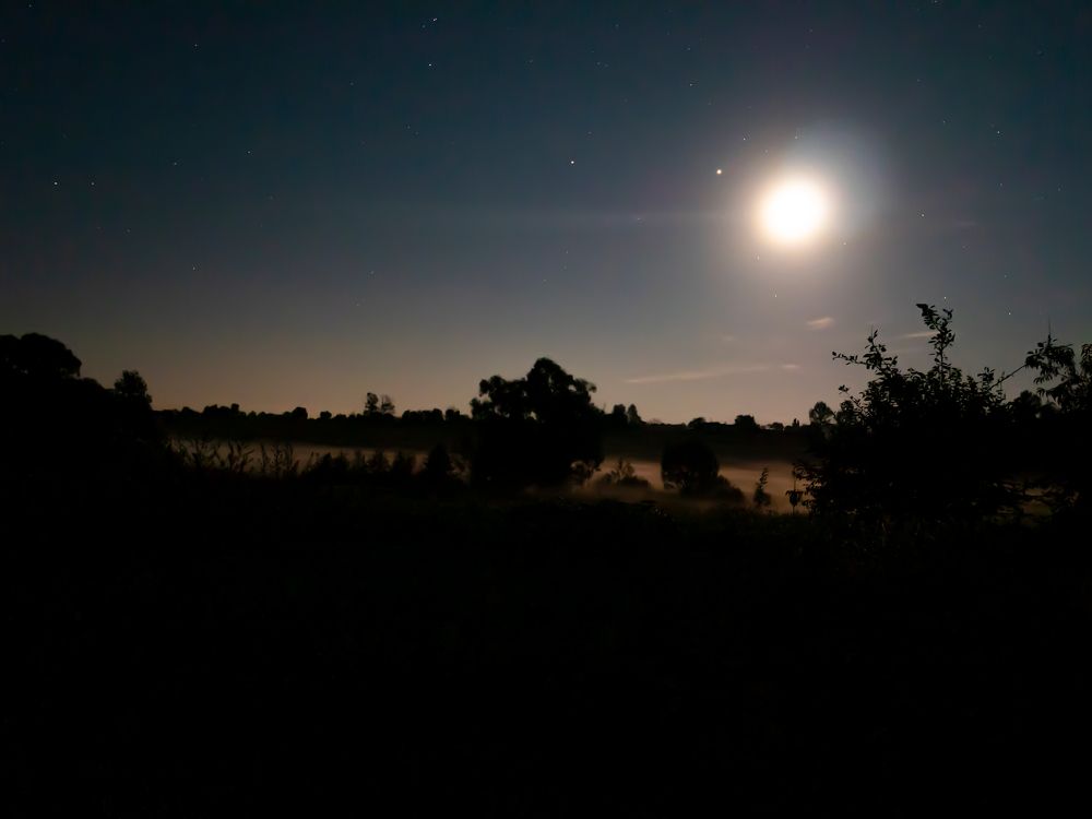 Heavenly horizon with the moon in the starry night sky.