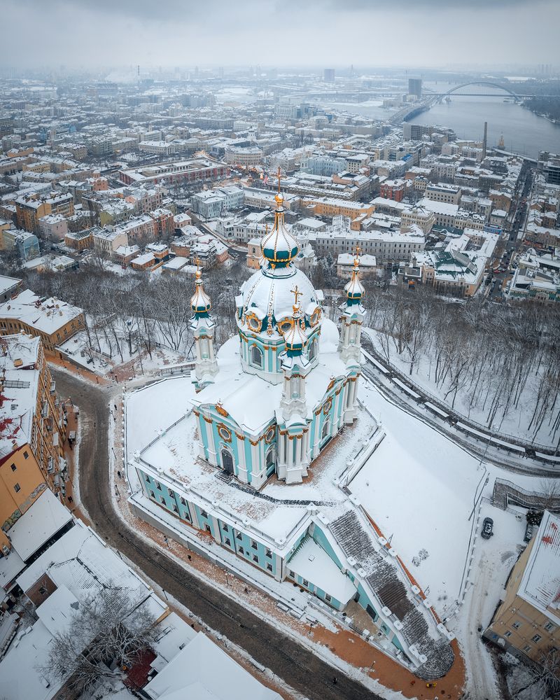 St. Andrew's Church and thousands of Podil roofs under the white cover of winter