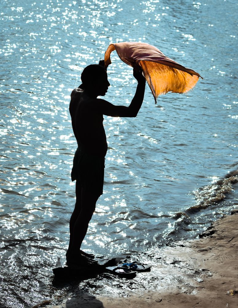 The picture of a man taking a bath in the Brahmaputra River