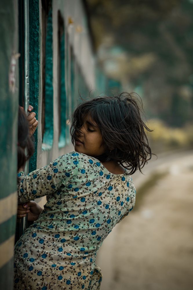 A brave child is enjoying the shuttle train journey.