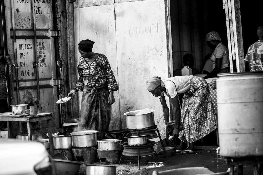 Burundian wOman's cooking food outside