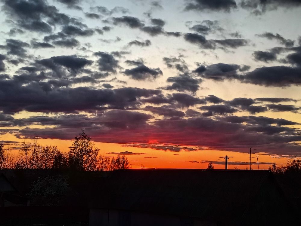 Black clouds over an orange sunset