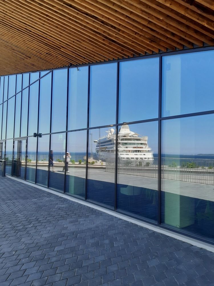 The reflection of the ship in the window.