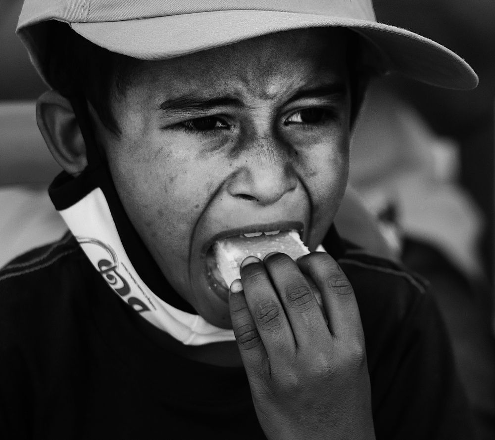 A little boy having his favourite biscuit.