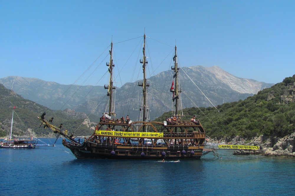 Ship off the coast of rocky mountainous islands
