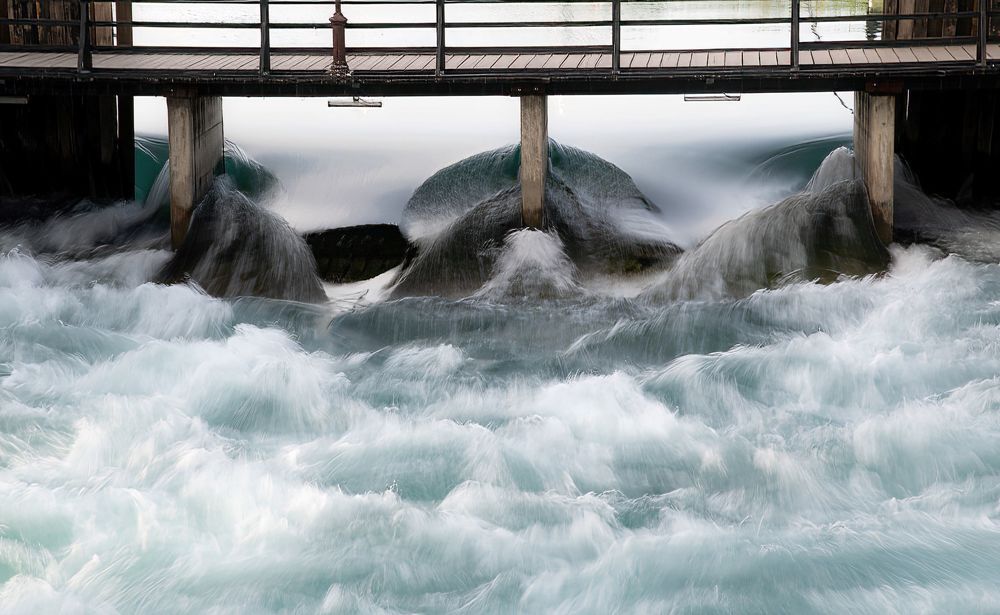 water stream under a foot bridge