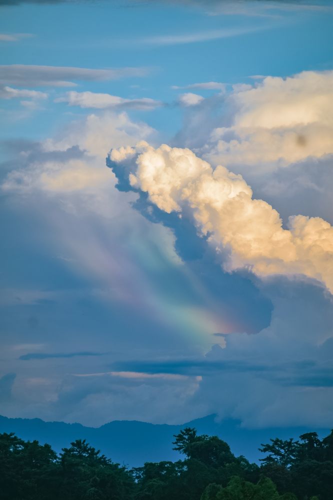 Rainbow In between clouds