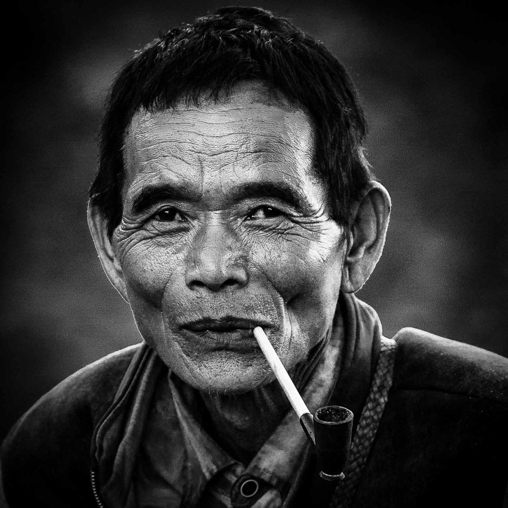 A local resident smokes a pipe, Chin State, Myanmar