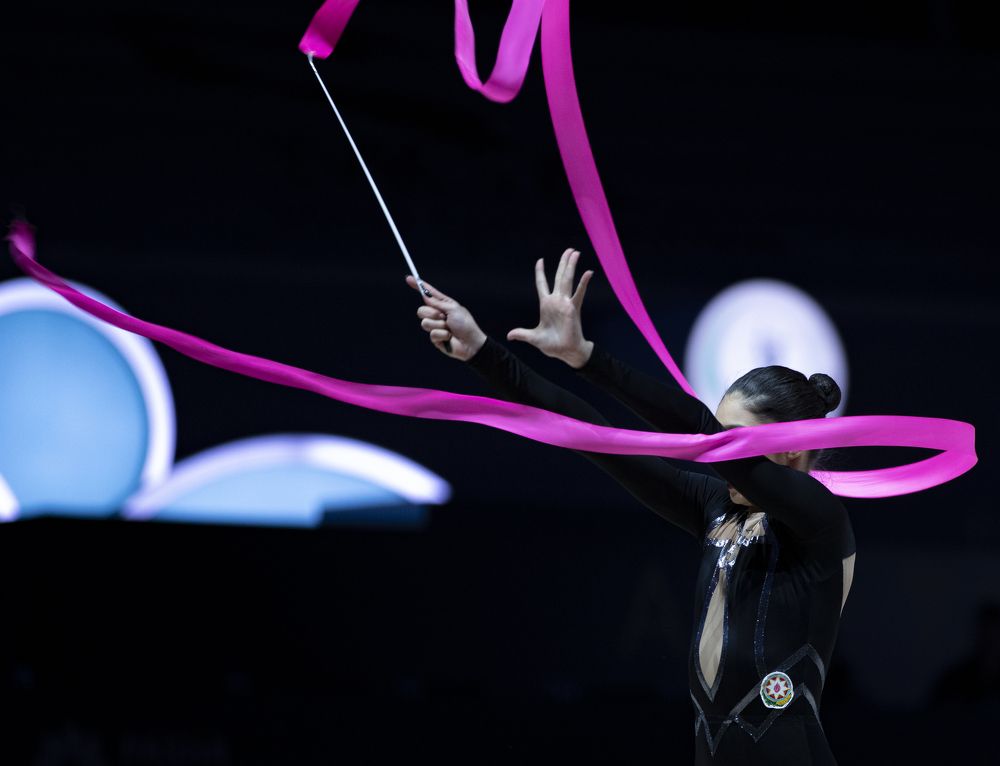 Gymnast and purple ribbon