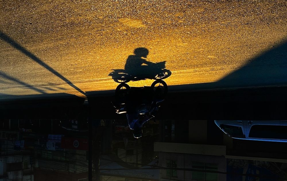 An upside down shadow of a bike with rider