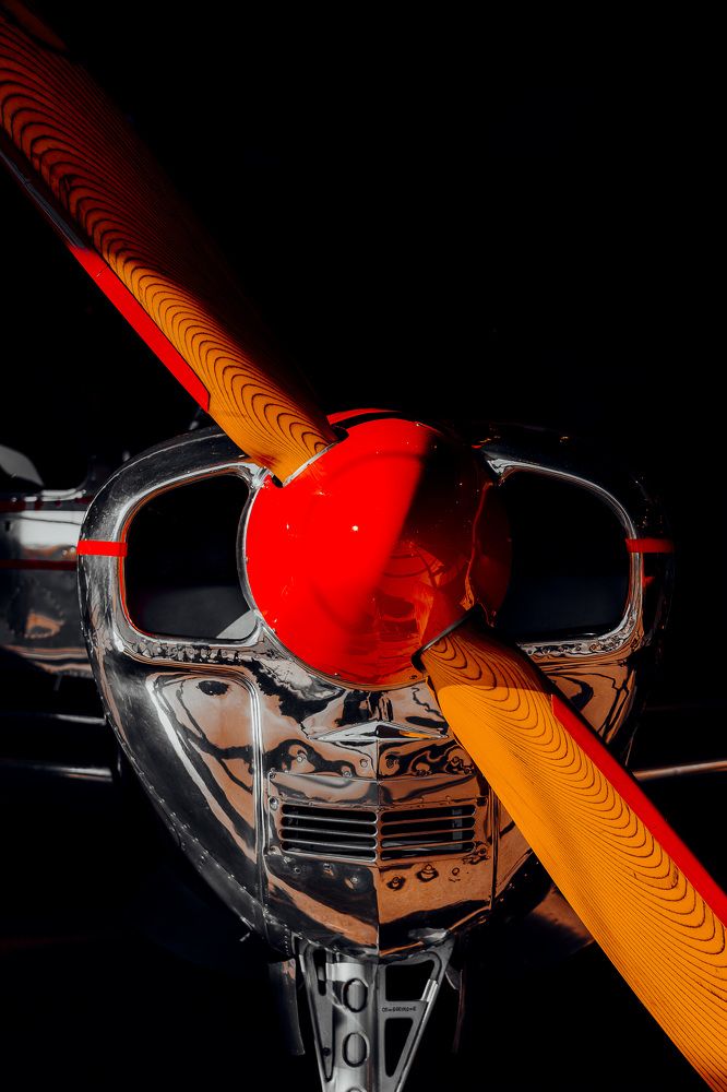 Red propeller Beechcraft plane