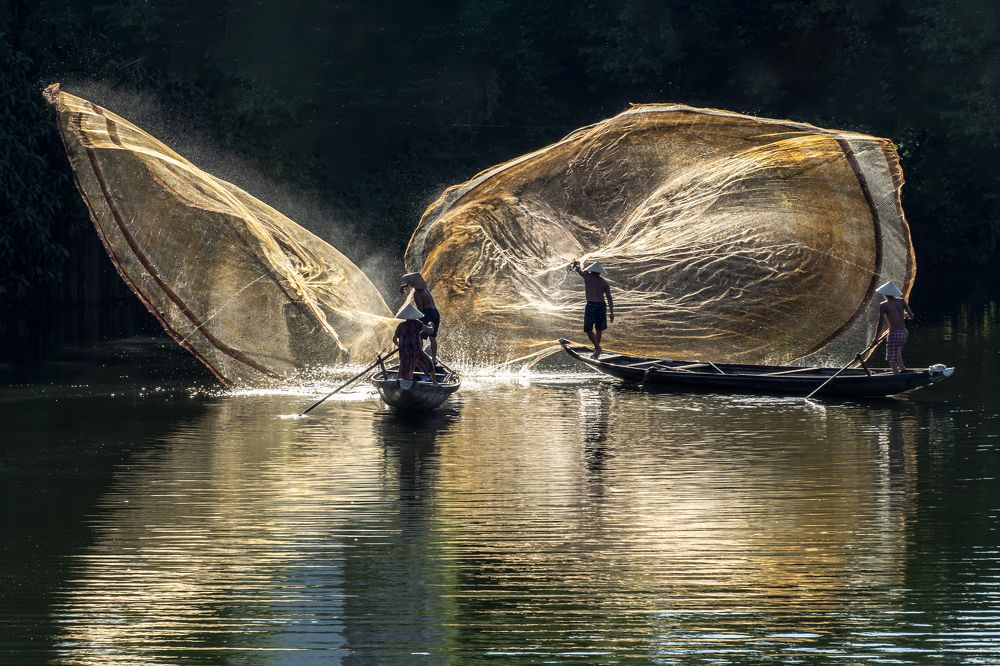 Throwing a net to catch fish in the river