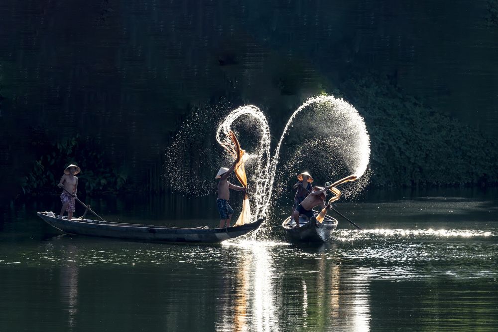 Throwing a net to catch fish in the river