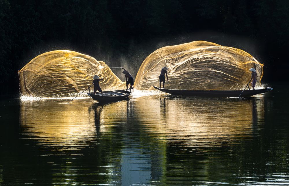 Throwing a net to catch fish in the river