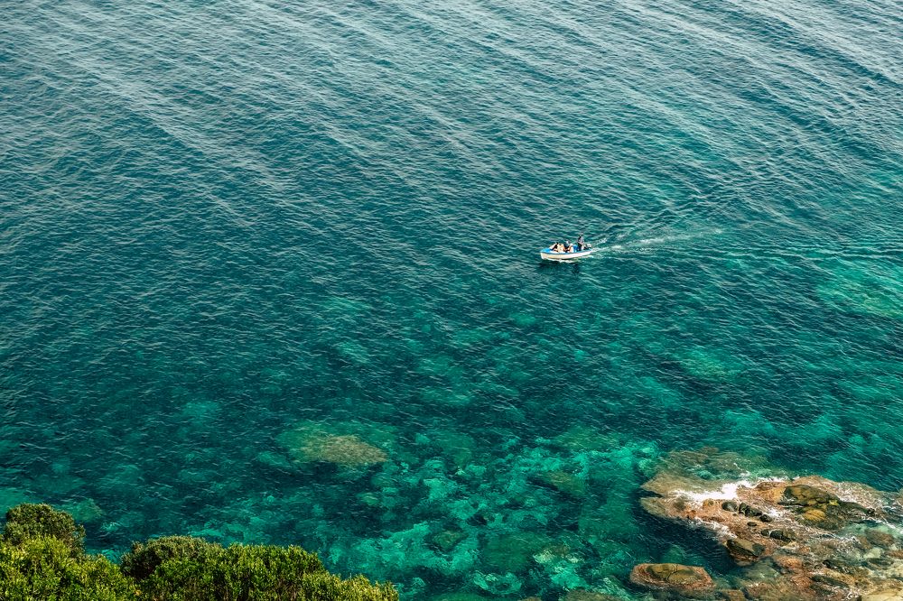 a small boat in the ocean
