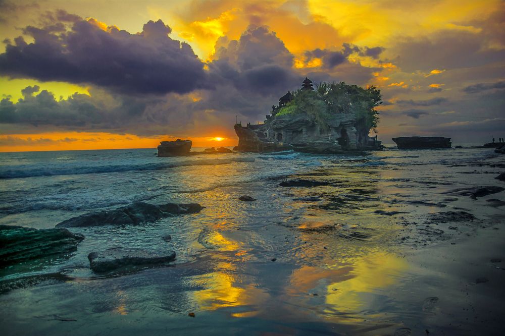 Dramatic sunset in Tanah Lot beach - Ancestral heritage architecture Bali