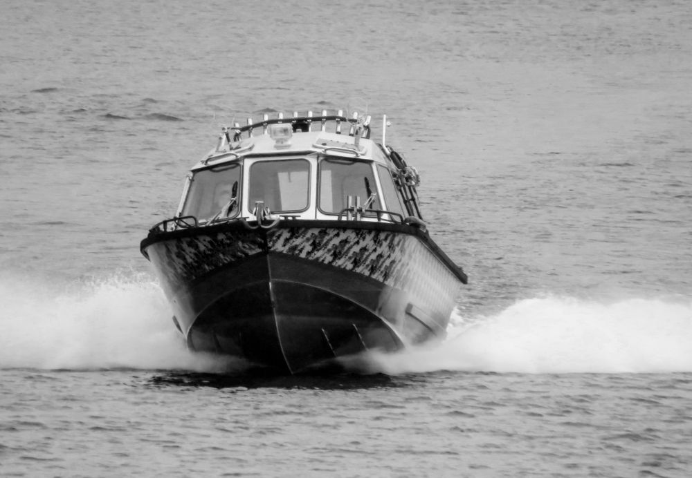 The boat is sailing on the lake