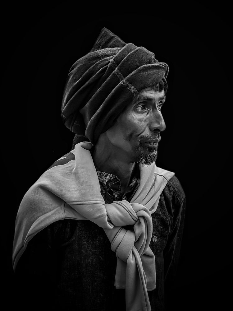 A worried homeless and hungry poor man standing by the road