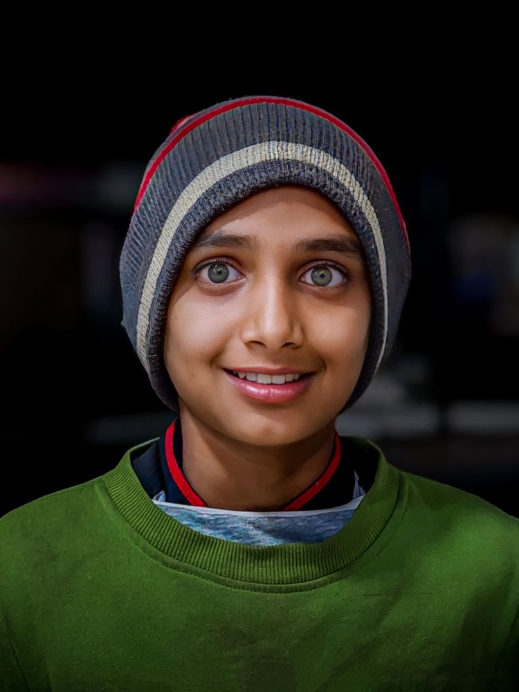 Bangladeshi street portrait of beautiful eyed kid smiling