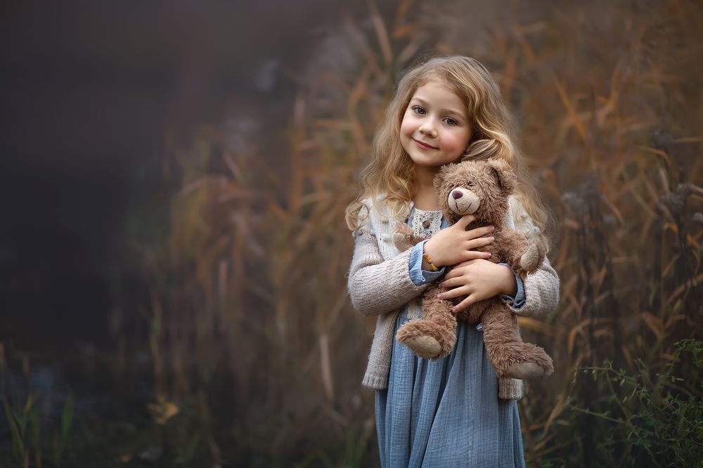 A girl and a teddy bear