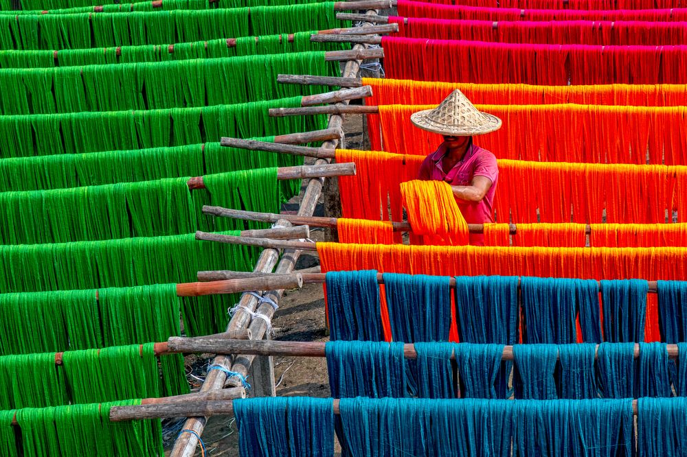Worker in colorful braids