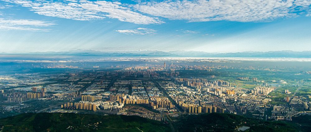 A plain city surrounded by mountains