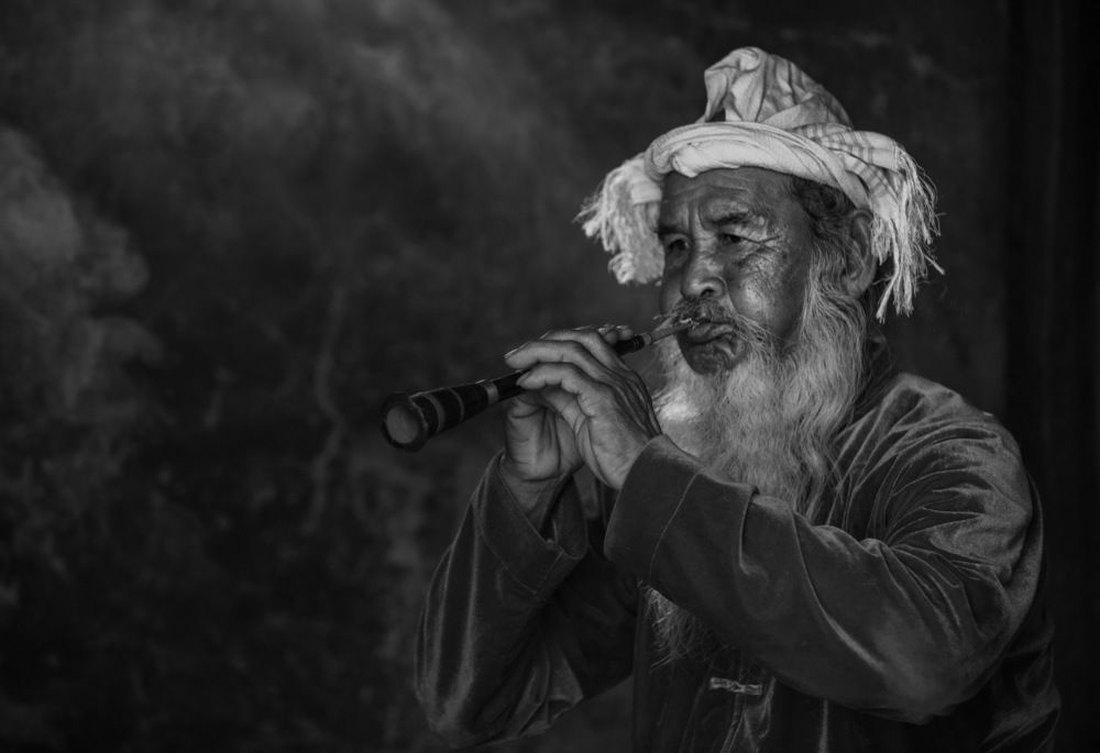 Portrait of Cham ethnic artisan playing Saranai trumpet