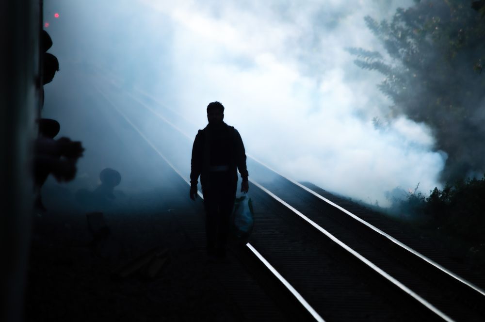 A passenger walking along railway.